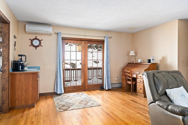 doorway to outside featuring light wood finished floors, baseboards, baseboard heating, a textured ceiling, and a wall mounted AC