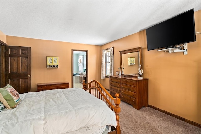 bedroom featuring baseboards, connected bathroom, and light colored carpet