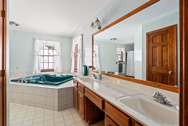 bathroom featuring double vanity, a garden tub, a sink, and tile patterned floors