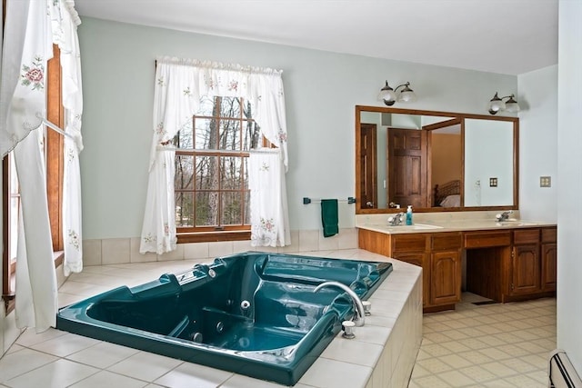 full bathroom with a baseboard heating unit, double vanity, a tub with jets, and a sink