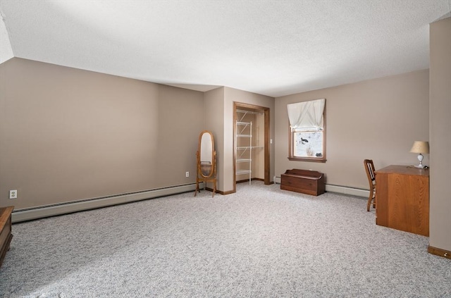 unfurnished office with a baseboard heating unit, carpet, a textured ceiling, and baseboards