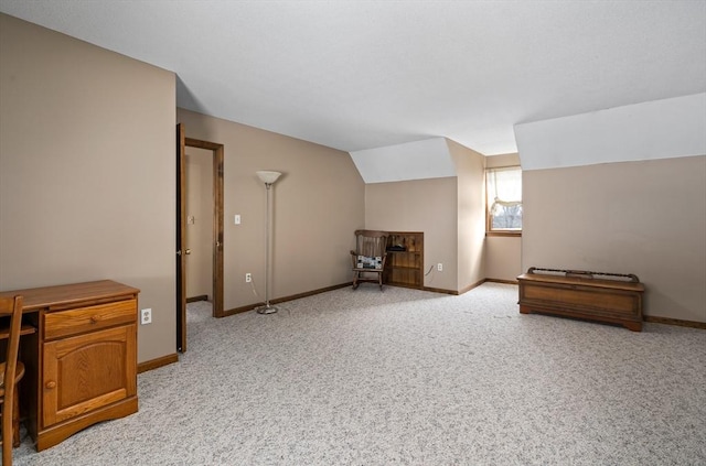 bonus room with light colored carpet, vaulted ceiling, and baseboards