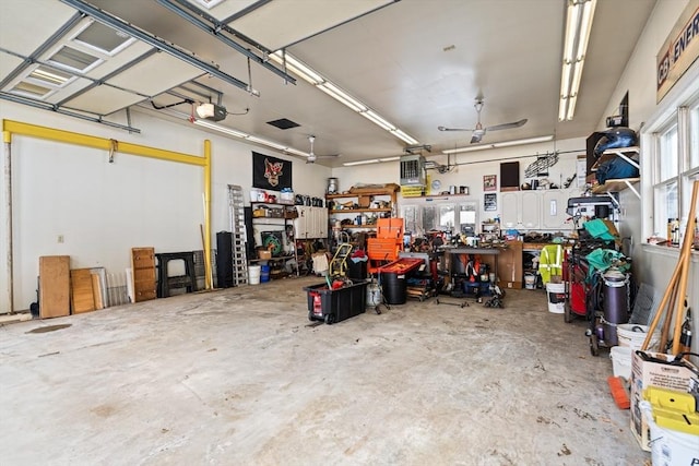 garage featuring a workshop area, a ceiling fan, and a garage door opener