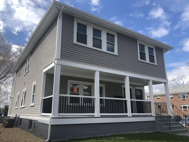 back of property featuring central AC and covered porch