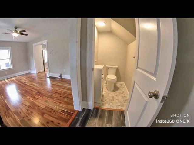 bathroom with hardwood / wood-style flooring, ceiling fan, and toilet