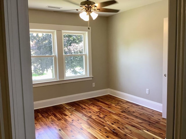 spare room with ceiling fan and wood-type flooring