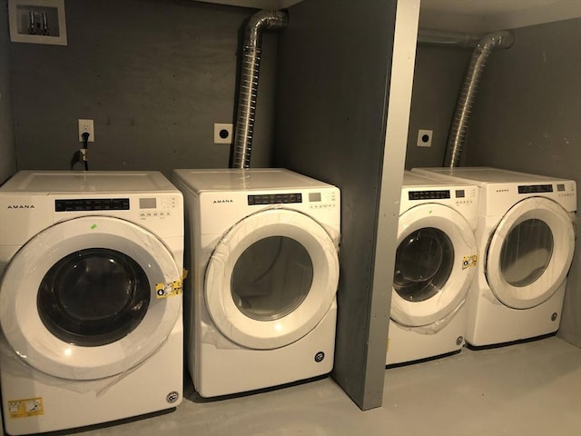 clothes washing area featuring separate washer and dryer