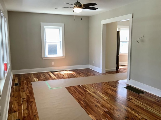 spare room with ceiling fan and dark wood-type flooring