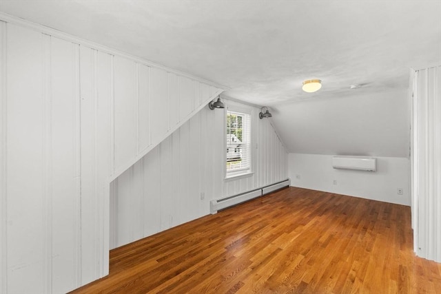 31 Webster St, Randolph, MA 02368 - bonus room with a baseboard radiator, a wall unit AC, wood finished floors, and vaulted ceiling