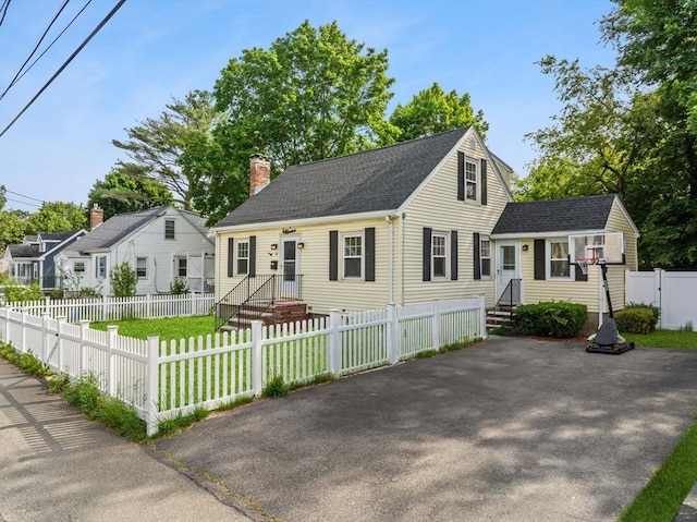 31 Webster St, Randolph, MA 02368 - cape cod house with a chimney, roof with shingles, and a fenced front yard