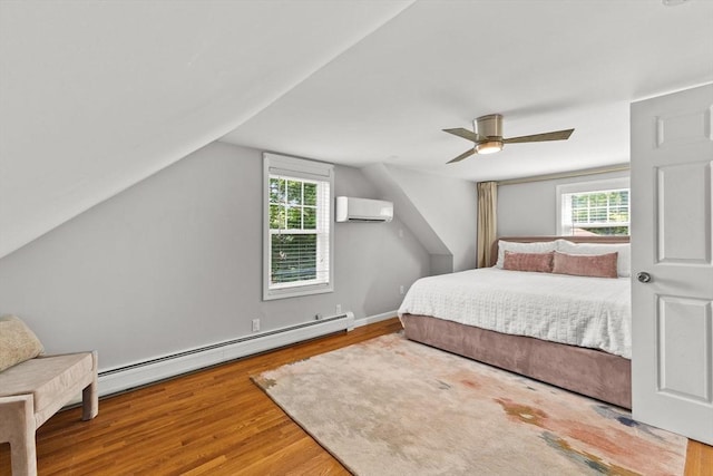 31 Webster St, Randolph, MA 02368 - bedroom with an AC wall unit, wood finished floors, ceiling fan, vaulted ceiling, and baseboard heating