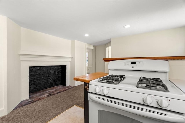 6 River St, Salem, MA 01970 - kitchen featuring white range with gas cooktop, a fireplace, recessed lighting, and light carpet