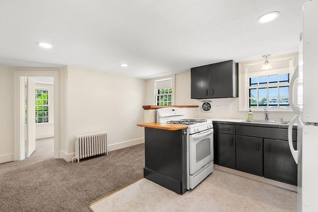 6 River St, Salem, MA 01970 - kitchen with radiator heating unit, white appliances, dark cabinets, plenty of natural light, and recessed lighting