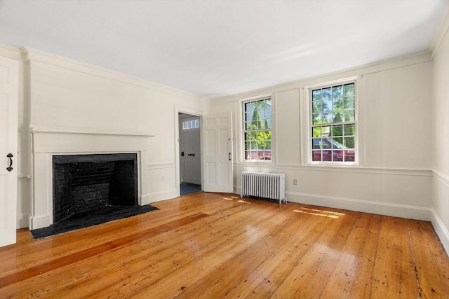 6 River St, Salem, MA 01970 - unfurnished living room with radiator, hardwood / wood-style flooring, and a fireplace with flush hearth