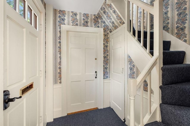 6 River St, Salem, MA 01970 - carpeted foyer featuring wallpapered walls, a decorative wall, a wainscoted wall, and stairs