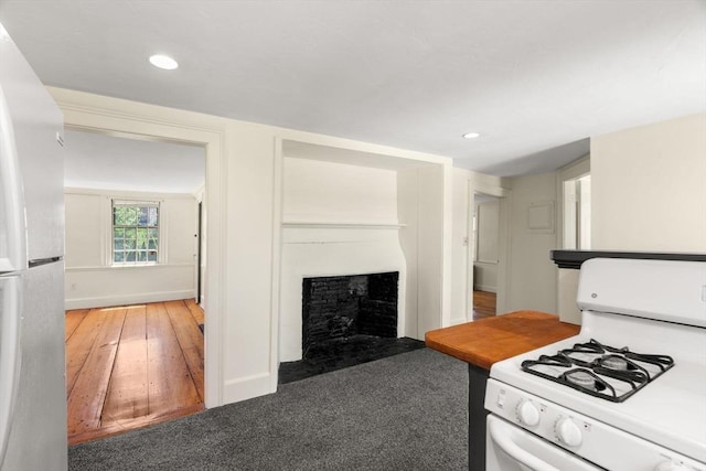 6 River St, Salem, MA 01970 - kitchen featuring white appliances, a fireplace, recessed lighting, and carpet