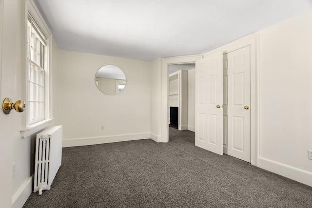 6 River St, Salem, MA 01970 - spare room with radiator heating unit and dark carpet