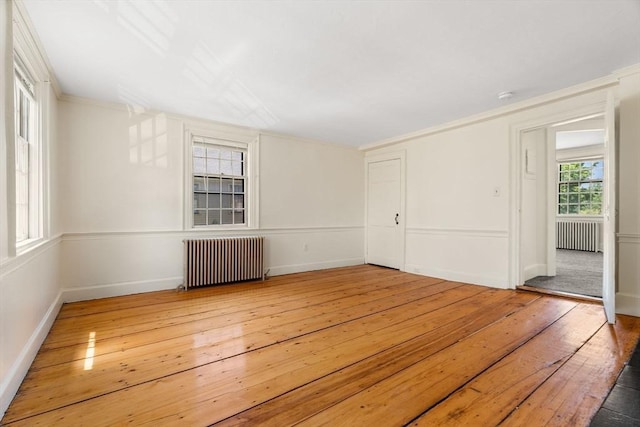 6 River St, Salem, MA 01970 - empty room with radiator heating unit, light wood-style floors, and ornamental molding