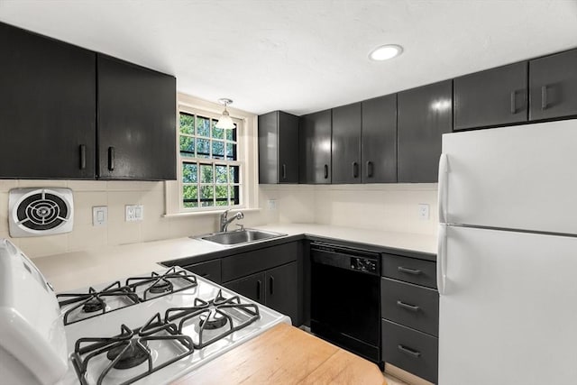 6 River St, Salem, MA 01970 - kitchen featuring freestanding refrigerator, dishwasher, dark cabinetry, light countertops, and decorative backsplash