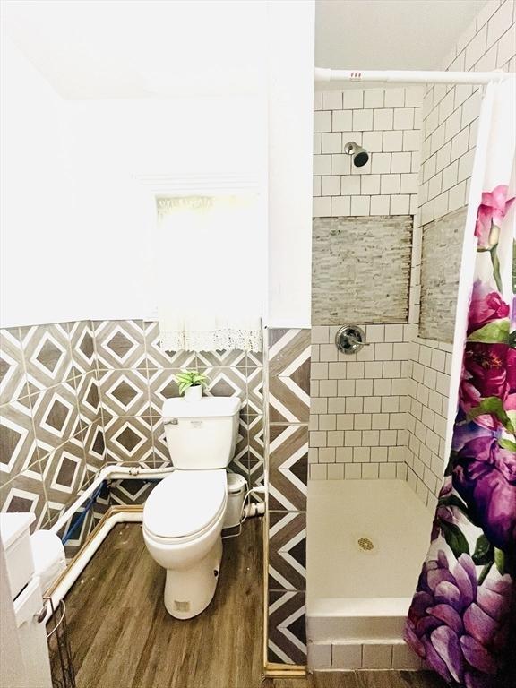 173 Brookway Rd, Boston, MA 02131 - bathroom with a stall shower, toilet, and wood finished floors