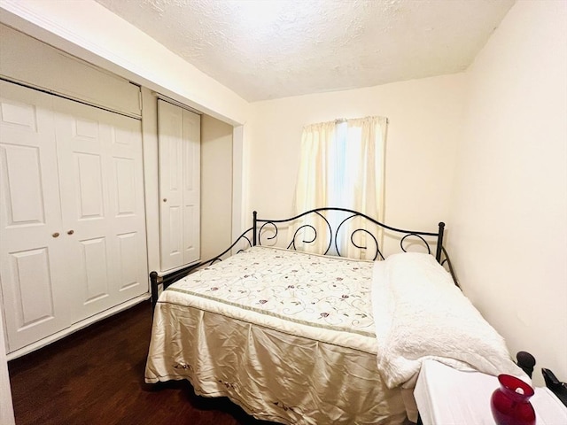 173 Brookway Rd, Boston, MA 02131 - bedroom featuring wood finished floors, a closet, and a textured ceiling