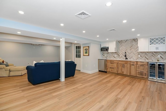 28 Smithshire Ests, Andover, MA 01810 - indoor wet bar with beverage cooler, stainless steel appliances, recessed lighting, backsplash, and light wood finished floors