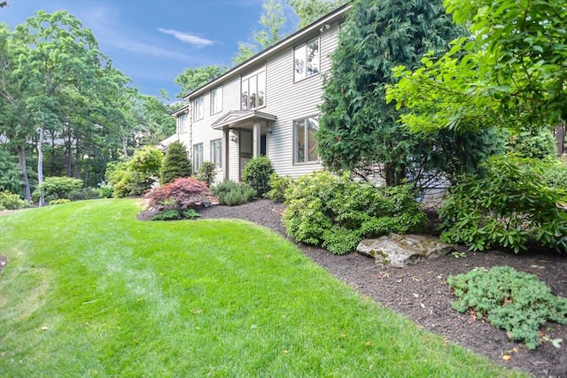 28 Smithshire Ests, Andover, MA 01810 - view of property exterior featuring a yard