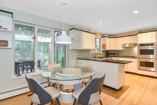 28 Smithshire Ests, Andover, MA 01810 - kitchen featuring stainless steel appliances, open shelves, under cabinet range hood, dark countertops, and a peninsula