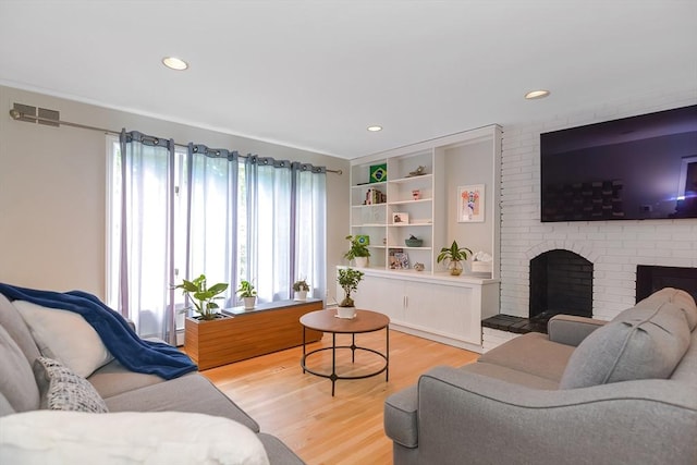 28 Smithshire Ests, Andover, MA 01810 - living area with light wood-style floors, a fireplace, and recessed lighting