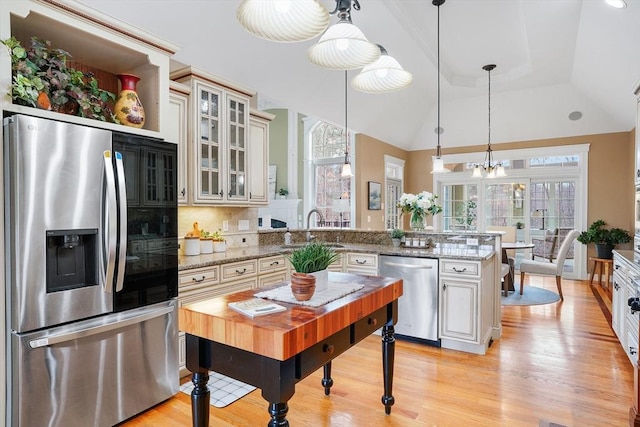 7 Buckhide Rd, Windham, NH 03087 - kitchen featuring stainless steel appliances, a peninsula, a sink, light wood-type flooring, and glass insert cabinets