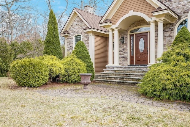 7 Buckhide Rd, Windham, NH 03087 - doorway to property featuring stone siding and a chimney
