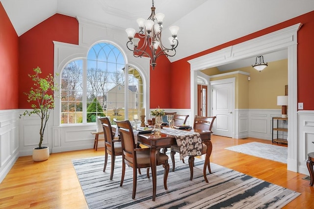 7 Buckhide Rd, Windham, NH 03087 - dining room with a decorative wall, wood finished floors, a chandelier, a wainscoted wall, and vaulted ceiling
