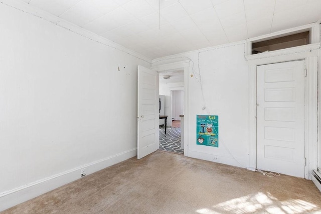 carpeted spare room featuring a baseboard radiator