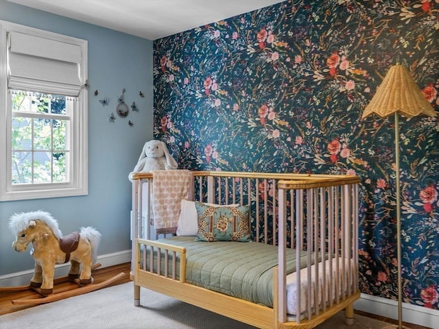 bedroom with baseboards and wood finished floors