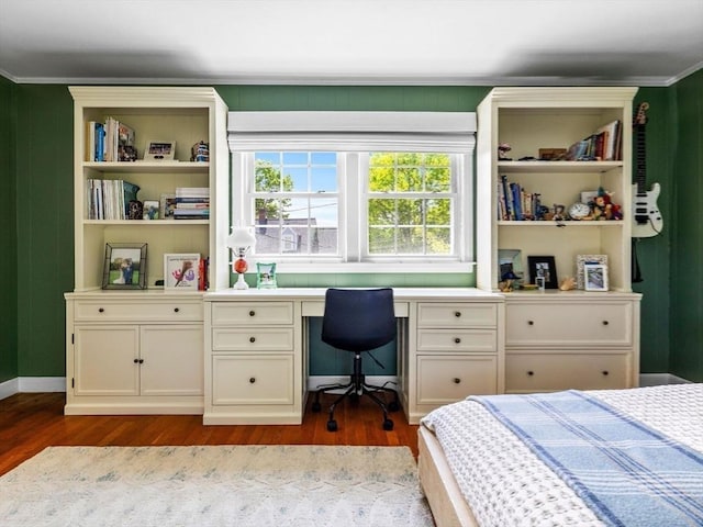bedroom with dark wood-style flooring, ornamental molding, and baseboards