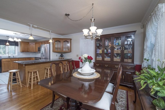 769 Federal St, Belchertown, MA 01007 - dining room with a chandelier, crown molding, and light wood finished floors