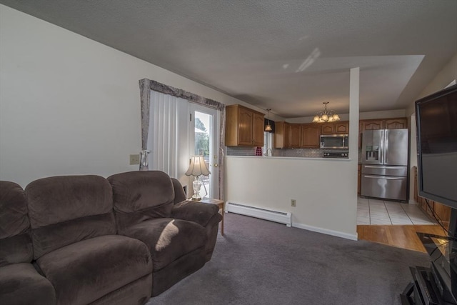 769 Federal St, Belchertown, MA 01007 - living area with a baseboard heating unit, a chandelier, and light colored carpet