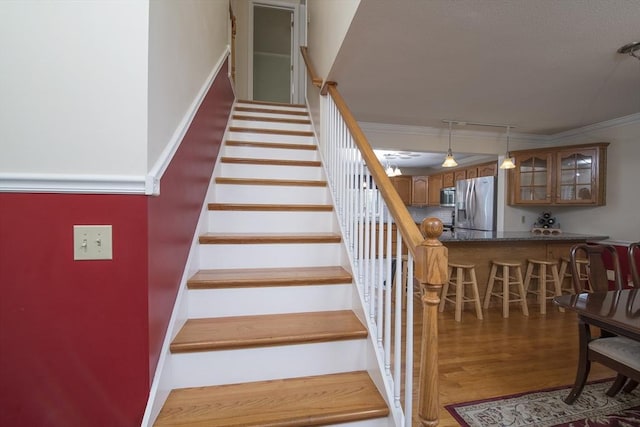 769 Federal St, Belchertown, MA 01007 - staircase with wet bar, crown molding, wood finished floors, and track lighting