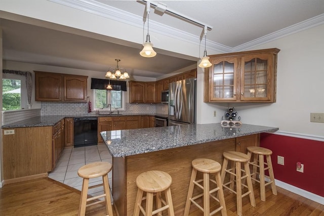 769 Federal St, Belchertown, MA 01007 - kitchen with stainless steel appliances, a peninsula, tasteful backsplash, glass insert cabinets, and a breakfast bar area