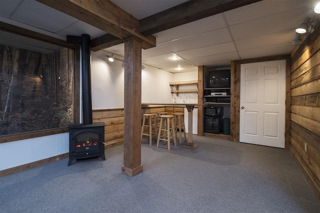 769 Federal St, Belchertown, MA 01007 - finished below grade area featuring a wood stove, wood walls, carpet flooring, and a dry bar