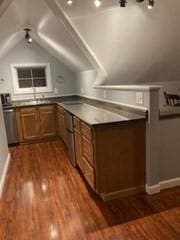 769 Federal St, Belchertown, MA 01007 - kitchen featuring dark wood finished floors, brown cabinetry, lofted ceiling, and dark countertops
