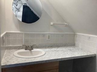 769 Federal St, Belchertown, MA 01007 - bathroom with vanity, vaulted ceiling, and decorative backsplash