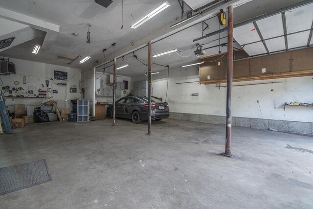 769 Federal St, Belchertown, MA 01007 - garage with a garage door opener and a workshop area