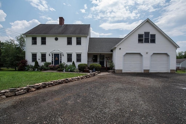 769 Federal St, Belchertown, MA 01007 - colonial house featuring a chimney, a front yard, a garage, covered porch, and asphalt driveway