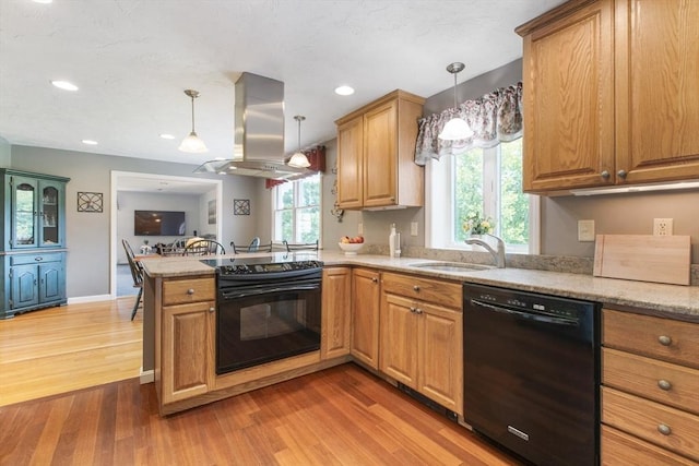 2 Harding Rd, Medway, MA 02053 - kitchen featuring black appliances, island range hood, a peninsula, light wood-style flooring, and decorative light fixtures