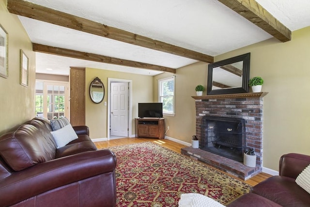 2 Harding Rd, Medway, MA 02053 - living room featuring beamed ceiling, plenty of natural light, wood finished floors, and a brick fireplace