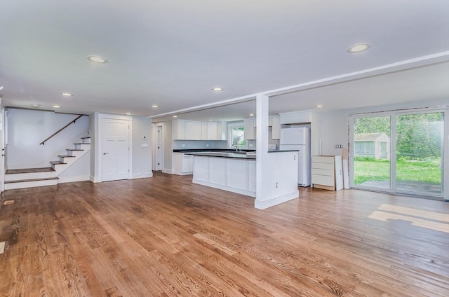 10 Briggs Ln, Marion, MA 02738 - unfurnished living room featuring plenty of natural light, recessed lighting, stairway, and light wood-style floors