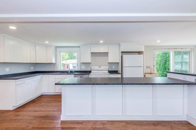 10 Briggs Ln, Marion, MA 02738 - kitchen with white appliances, plenty of natural light, dark countertops, recessed lighting, and white cabinetry