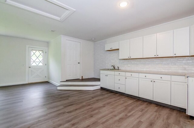 10 Briggs Ln, Marion, MA 02738 - kitchen with wood finished floors, white cabinetry, backsplash, and light countertops