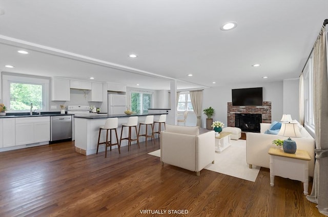 10 Briggs Ln, Marion, MA 02738 - living area featuring plenty of natural light, dark wood finished floors, a brick fireplace, and recessed lighting